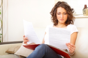 woman-reading-paperwork-at-home